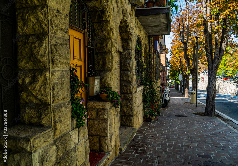 old italian house and empty street during warm autumn day in old city san marino