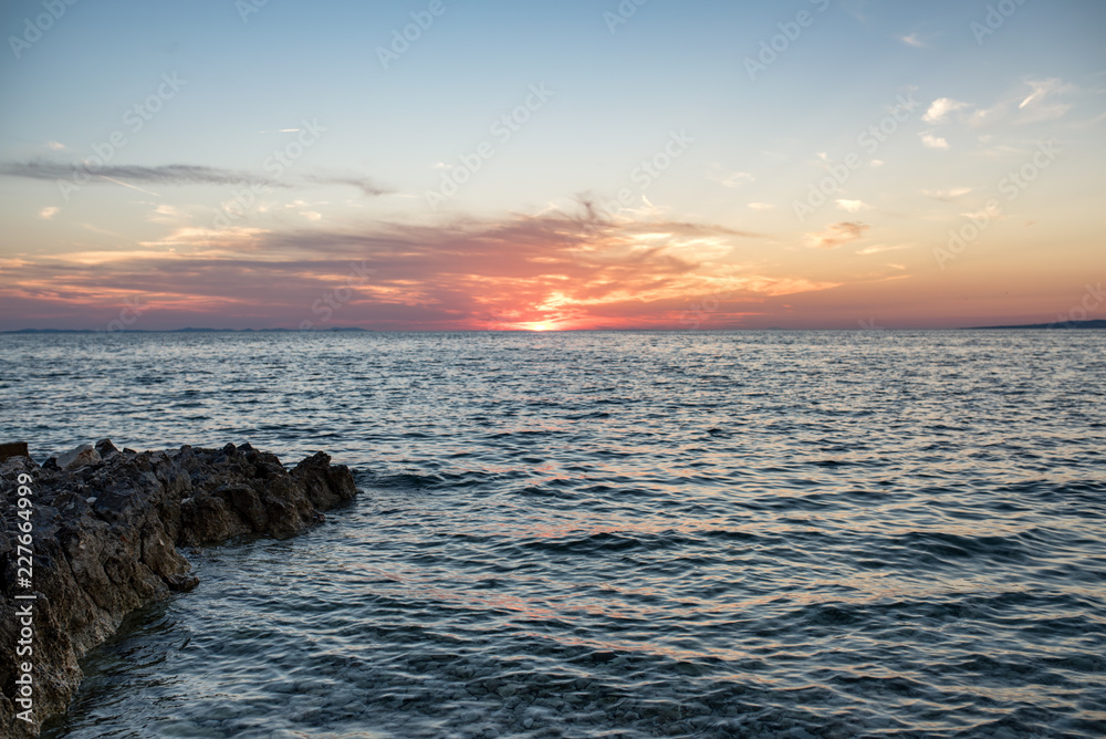 Beautiful sunset over the sea with rocky shore Beautiful sunset over the sea with rocky shore