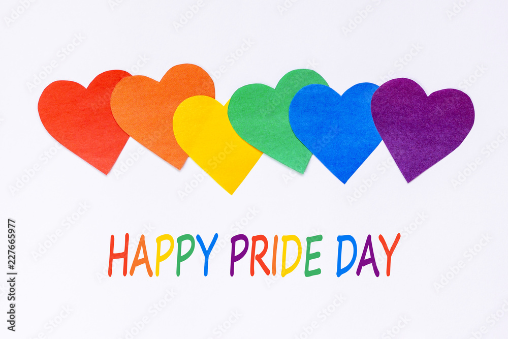 LGBT flag symbol. Six paper hearts of rainbow color on white background with text happy pride day. Concept greeting card