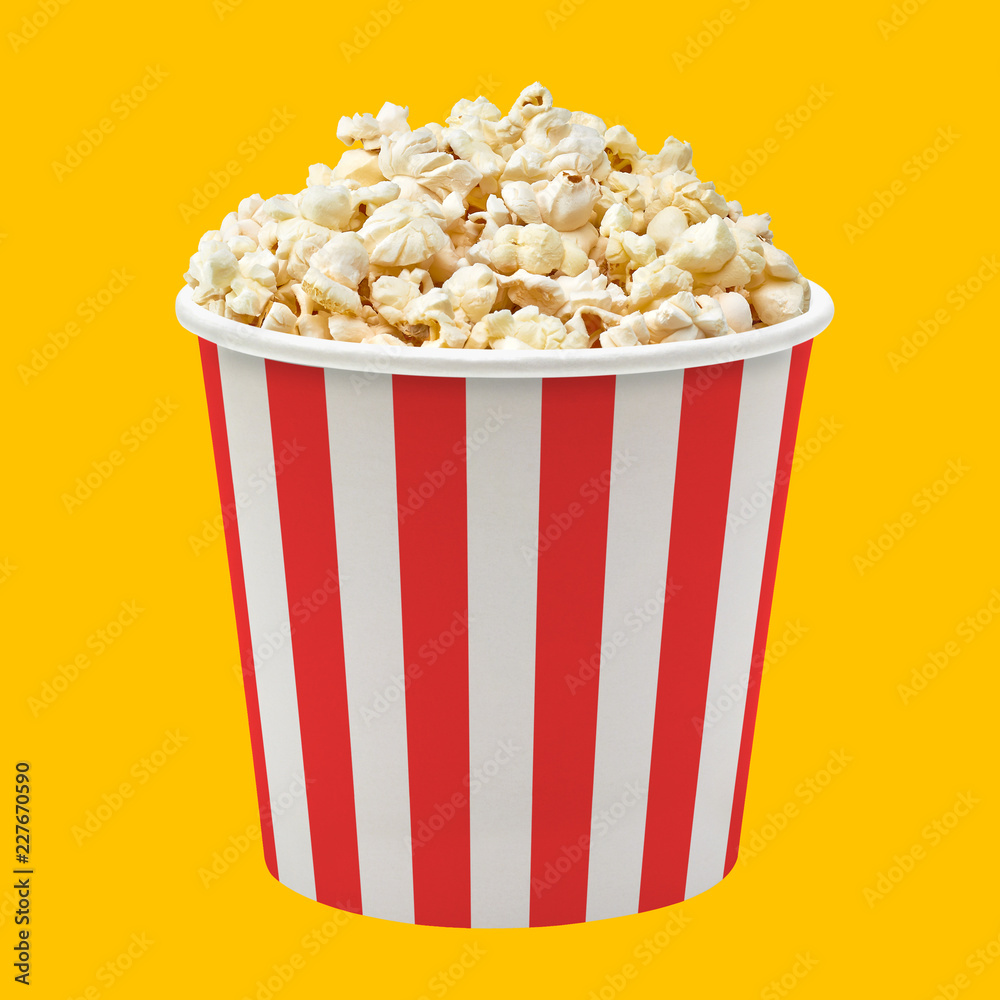 Popcorn in striped paper or carton bucket isolated on white background Popcorn in striped paper or carton bucket isolated on white background