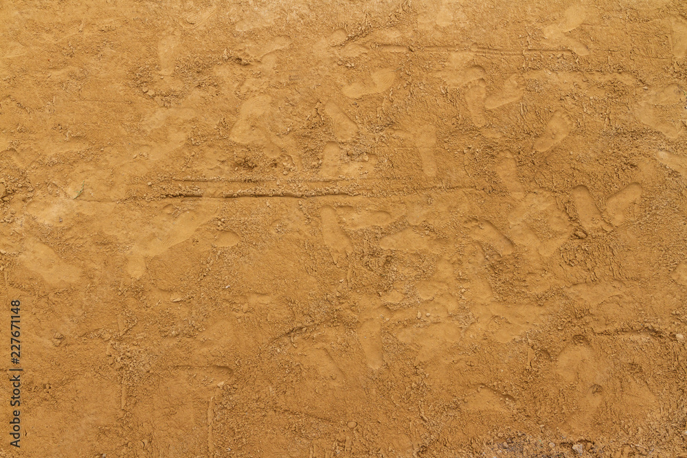 Fototapeta premium Sand background in construction site and Children footprints.
