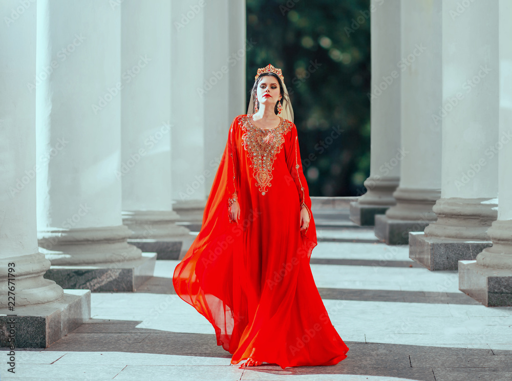 Gorgeous proud dark-haired confident haseki sexy queen roksolana in amazing  expensive luxury red long flying dress with gold, beads and precious stones,  wearing crown and earrings. art fantasy photo Stock-Foto | Adobe