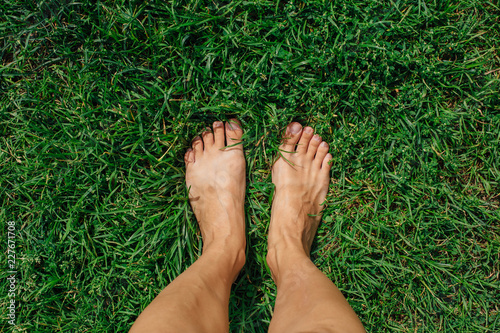 Bare woman's feet on the fresh green grass