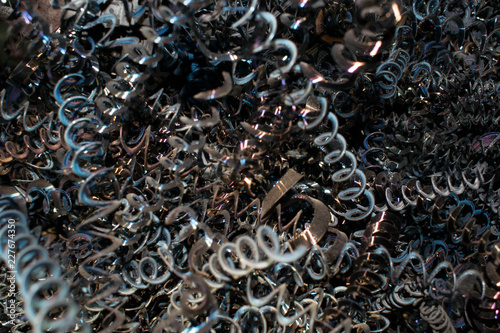 Metal chips in the form of a spiral waste from turning production for the design background