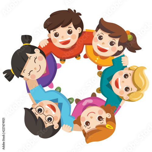 Friendship boys and girls standing arm in arm forming a circle looking up at the viewer. Happy group children isolated.
