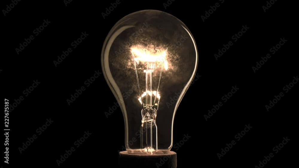 Realistic light bulb blinking on black background.