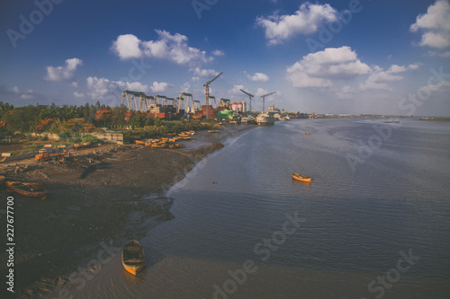 Vászonkép view of the river industrial boats landscape wallpaper india surat gujarat cloud