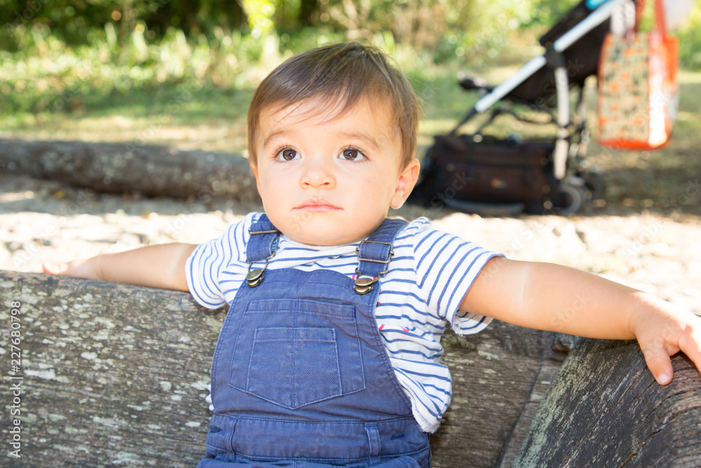 Portrait of little boy having a good happy relax time in the park wood bench Portrait of little boy having a good happy relax time in the park wood bench