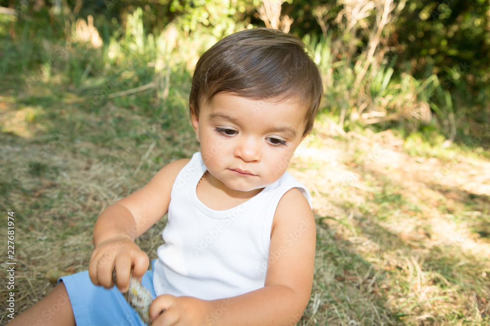 Happy little boy playing in summer garden grass park Happy little boy playing in summer garden grass park