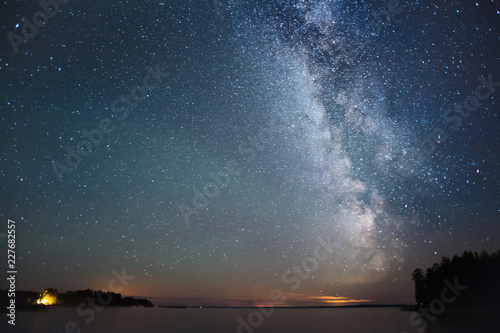 Milky Way and stars above lake. © ekim