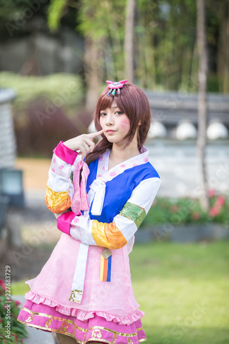Portrait of Hanbok costume young woman looking and smile in korean park