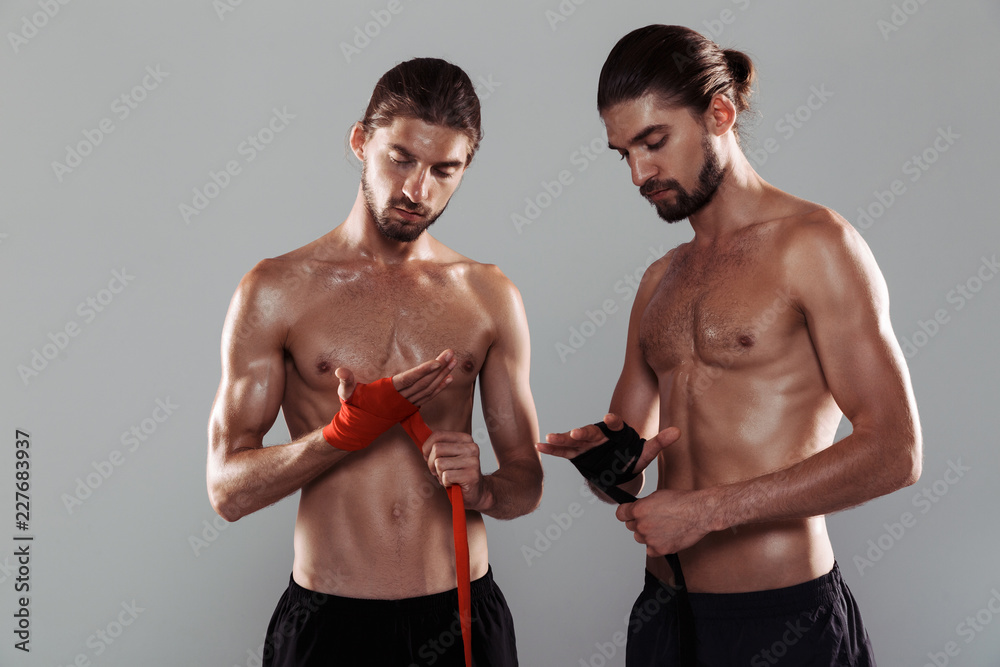 Portrait of a two muscular shirtless twin brothers Portrait of a two muscular shirtless twin brothers