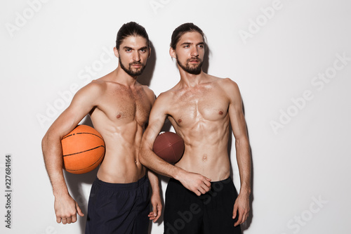 Portrait of a two muscular shirtless twin brothers