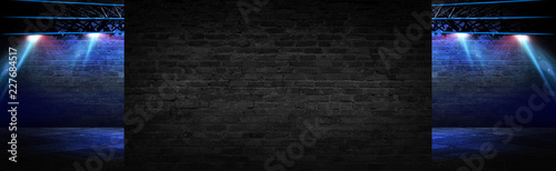 Empty brick wall background with neon lights, spotlights.