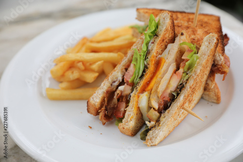 Club sandwich , Sandwich with egg bacon chicken tomato with fried outdoor restaurant background