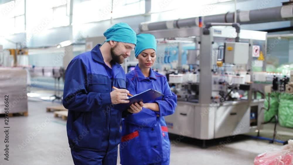 Two employees go through the plant and talk Two employees go through the plant and talk