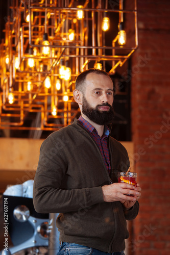 businessman male brunette beard glass hold cafe office house loft brave bearded hipster mulled wine