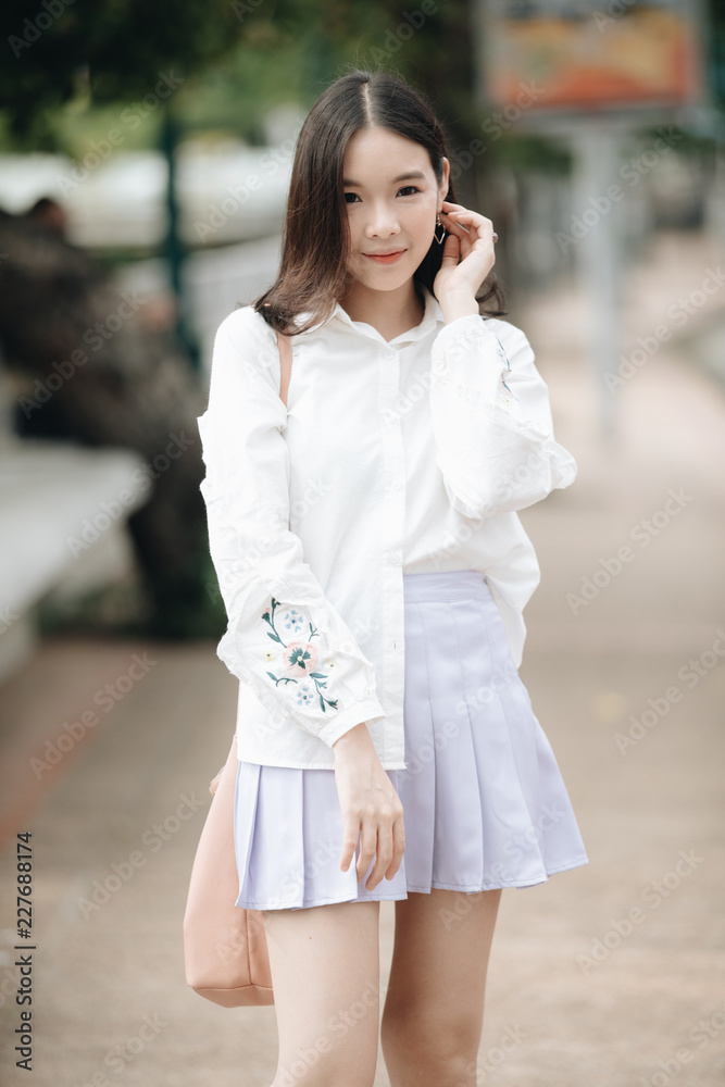 portrait of asian girl with white shirt and skirt looking in outdoor nature vintage film style portrait of asian girl with white shirt and skirt looking in outdoor nature vintage film style