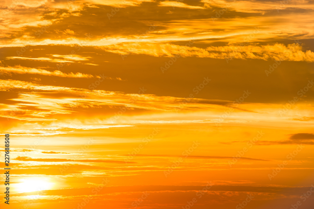 Orange sunset sky with clouds for nature background
