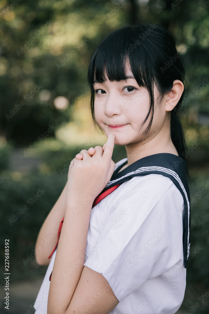 Portrait of asian japanese school girl costume looking at park outdoor film vintage style Portrait of asian japanese school girl costume looking at park outdoor film vintage style