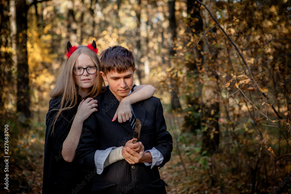 Teenagers in Halloween costumes in the woods Teenagers in Halloween costumes in the woods