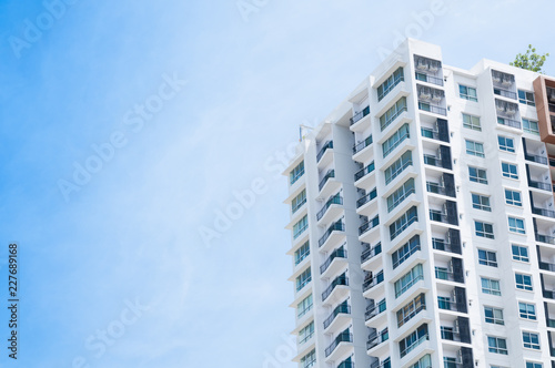 New building architecture on blue sky background,Low angle architectural exterior view of modern © rawintanpin