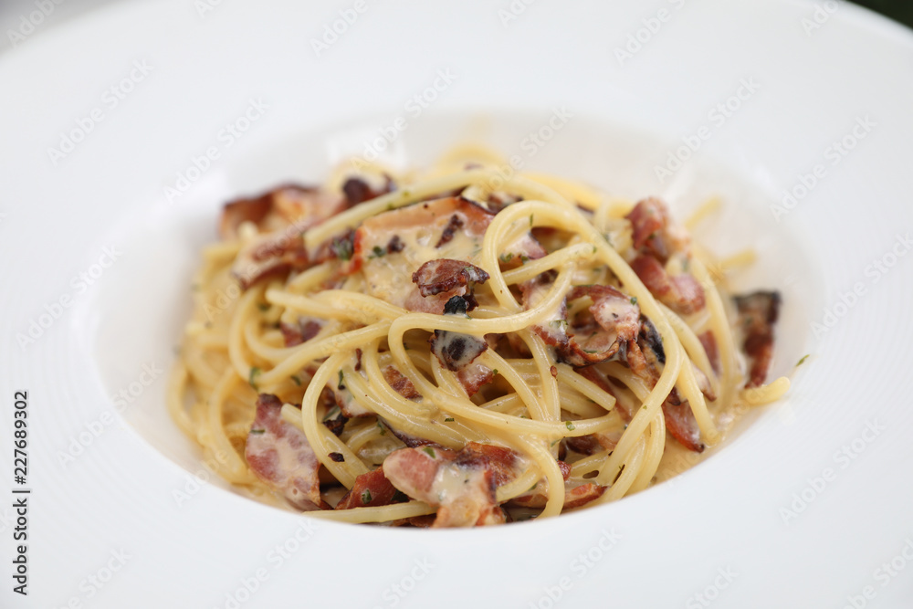 Spaghetti carbonara , Spaghetti white sauce with cheese bacon in outdoor restaurant italian food