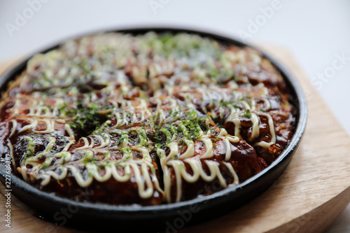 Japanese food okonomiyaki , Japanese pizza on wood plate photo