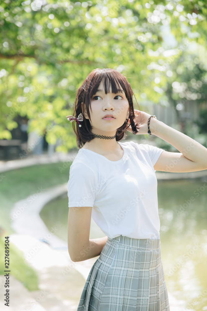 portrait of asian girl with white shirt and skirt looking in outdoor nature vintage film style portrait of asian girl with white shirt and skirt looking in outdoor nature vintage film style