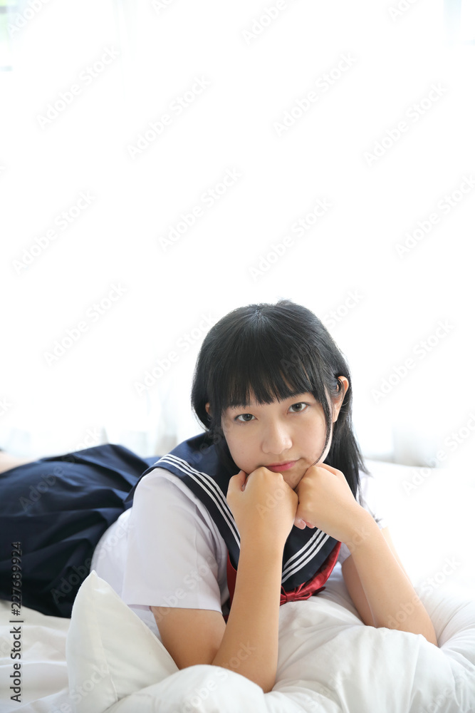 Portrait japanese school girl in white tone bed room Portrait japanese school girl in white tone bed room