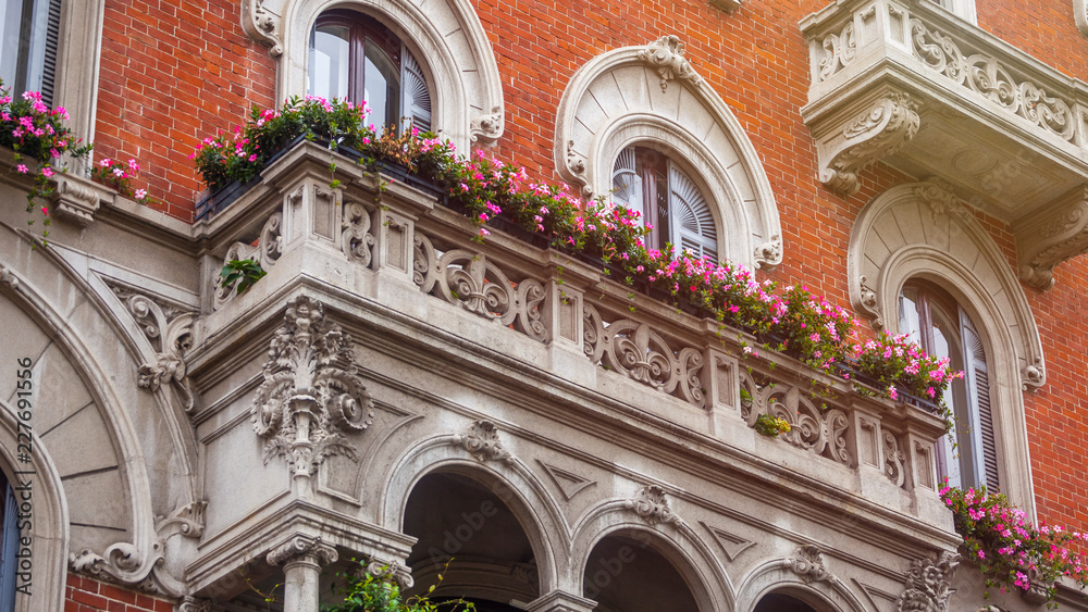 houses with flowers on the windows in Milan, Italy