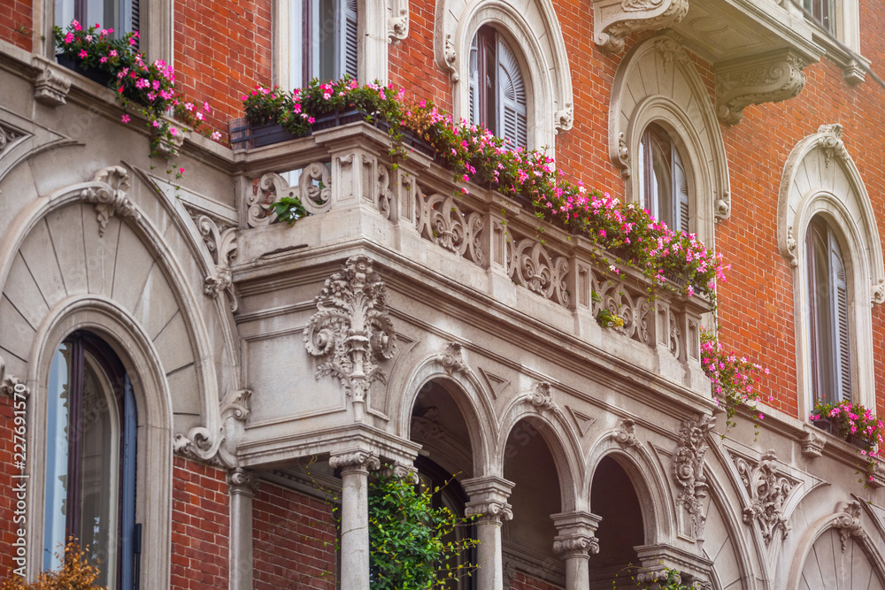 houses with flowers on the windows in Milan, Italy