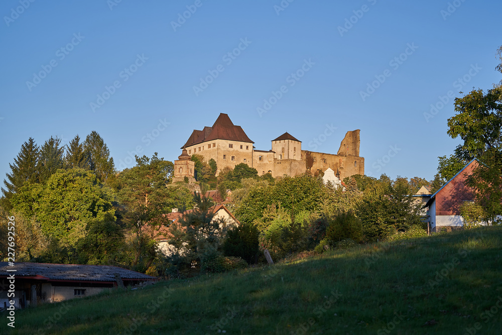 Fototapeta premium Lipnice nad Sázavou, large gothic style castle in Czech Republic taken in sunny evening golden light before sunset during the autumn, Czech touristic attractions.