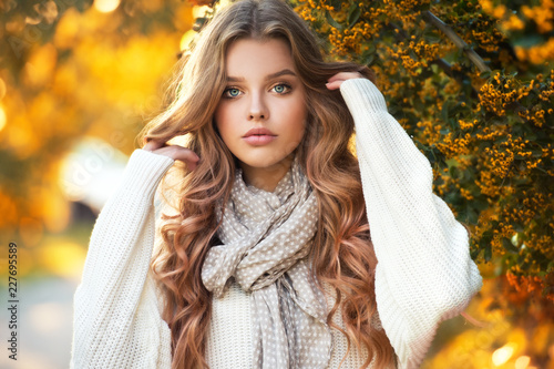 Beautiful girl walking outdoors in autumn.
