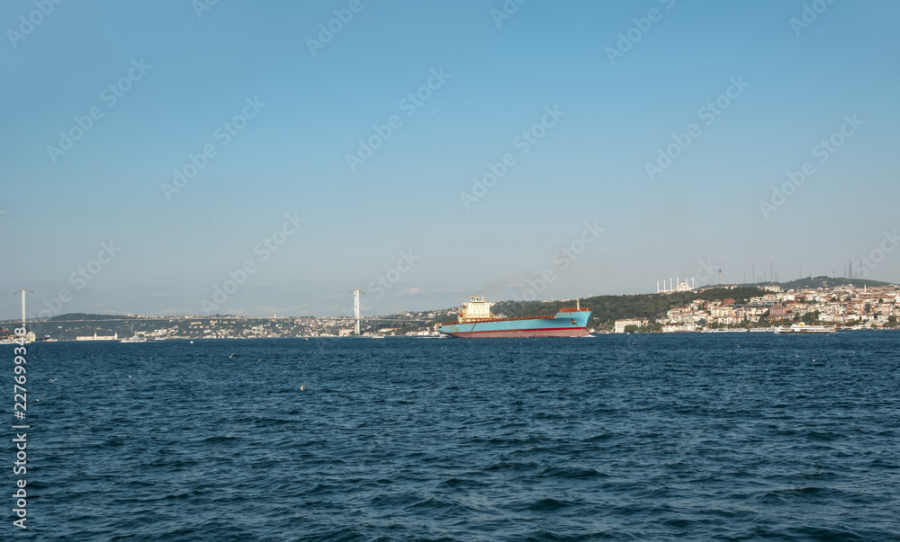 Beautiful View touristic landmarks from sea voyage on Bosphorus. Cityscape of Istanbul at sunset - old mosque and turkish steamboats, view on Golden Horn