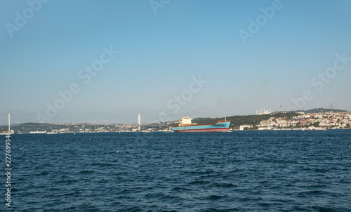 Beautiful View touristic landmarks from sea voyage on Bosphorus. Cityscape of Istanbul at sunset - old mosque and turkish steamboats  view on Golden Horn