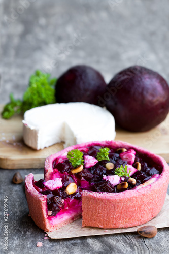 Homemade  balsamic beetroot and goat's cheese quiche on wooden table photo