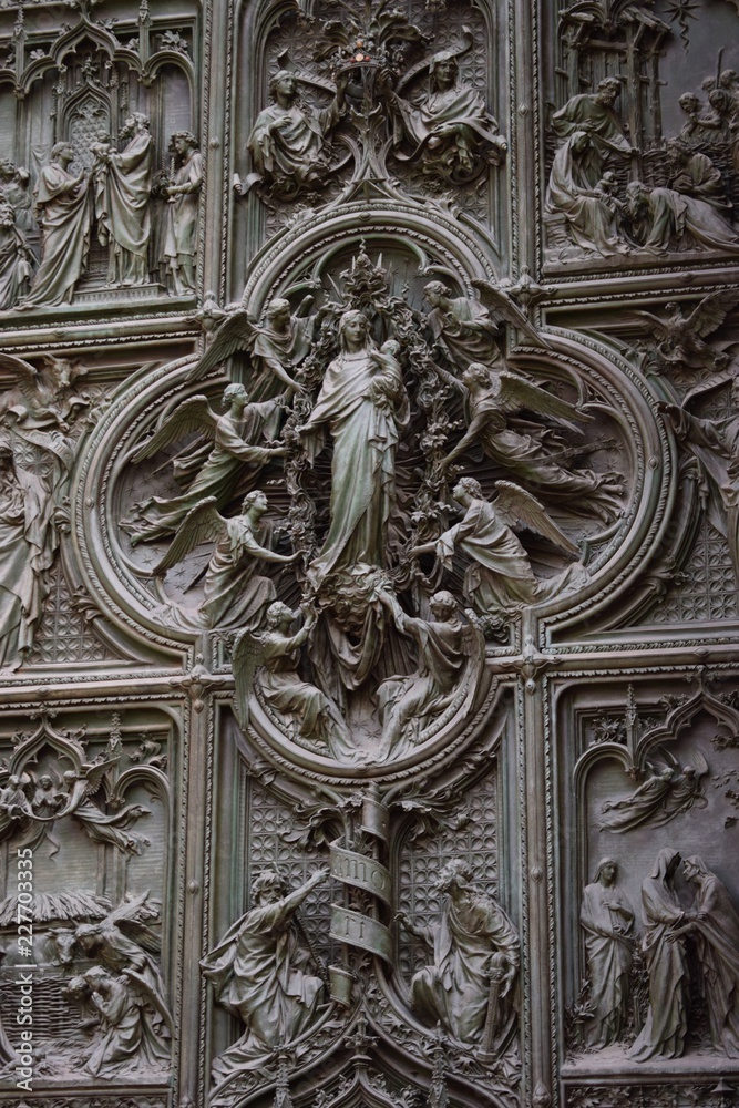 image of the Virgin Mary surrounded by angels at the door of Milan Cathedral, Italy