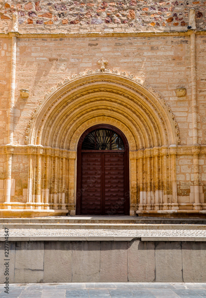 Ancient ornate wooden door of a church in Ciudad Real, Spain.