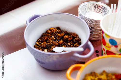 Homemade granola with nuts and seeds in thaplate for healthy breakfast