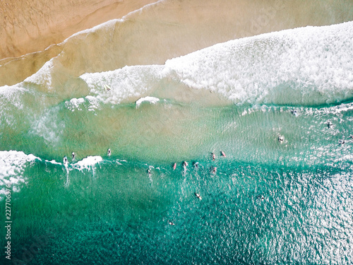 surfer waiting on beach for the next big wave in porto, portugal
