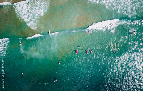 surfer waiting on beach for the next big wave in porto, portugal