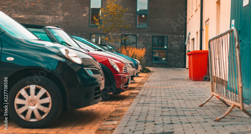 A selection of modern cars parked up against a new housing estate