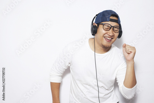 Happy Young Man Dancing while Listening Music