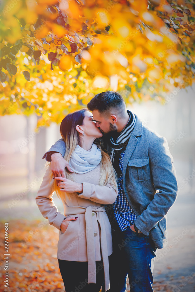 young couple in autumn season alley. Fall season young couple in autumn season alley. Fall season