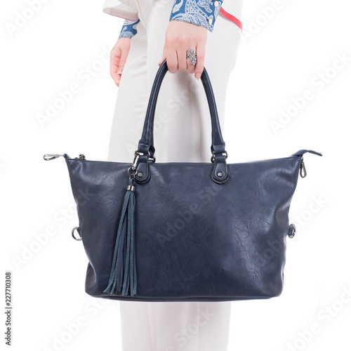  woman with blue handbag in hands. Isolated white background.