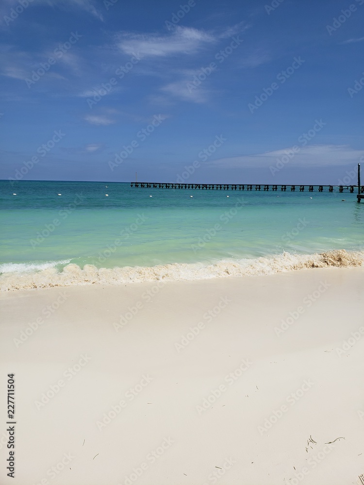 SAND, TURQUOISE SEA AND BLUE SKY IN THE CARIBBEAN.