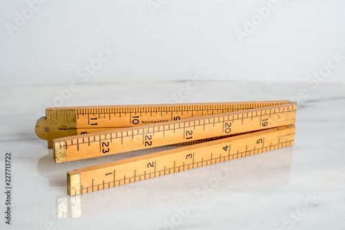 vintage carpenter's boxwood wooden folding ruler isolated on white background