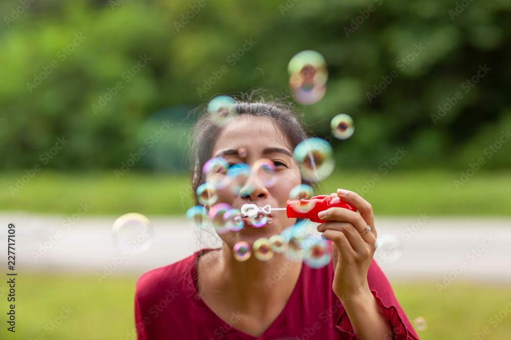 young asian woman with Carmen red dress blowing bubble young asian woman with Carmen red dress blowing bubble