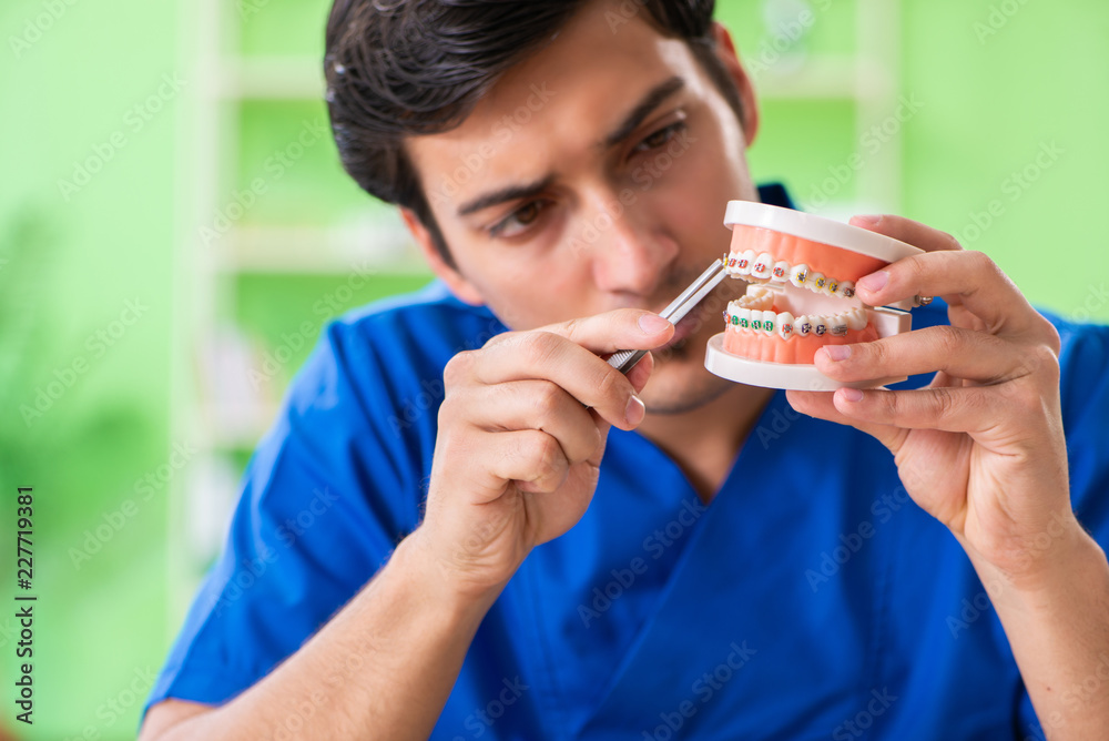 Man dentist working on new teeth implant Man dentist working on new teeth implant
